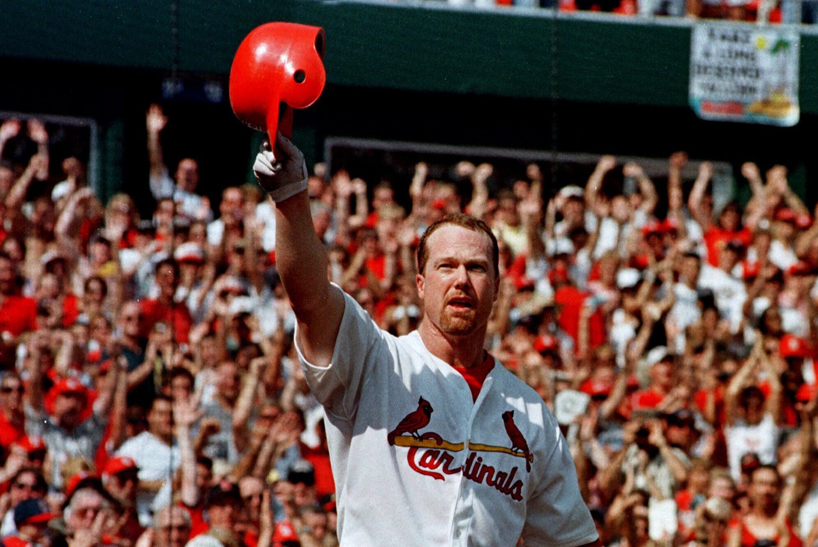 Mark McGwire tips his helmet to a cheering Busch Stadium crowd during his 1998 home run record chase