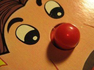 Glowing red nose buzzer light on the Operation game board