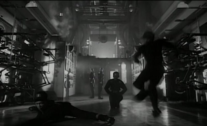 Rhythm Nation video dancers walking in military-style formation through the warehouse set