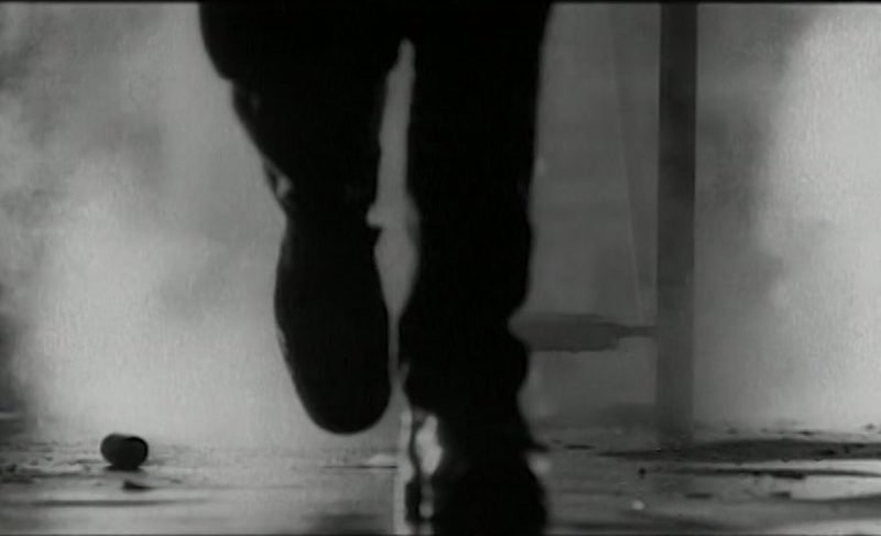 Rhythm Nation dancers silhouetted against light beams in the black-and-white video