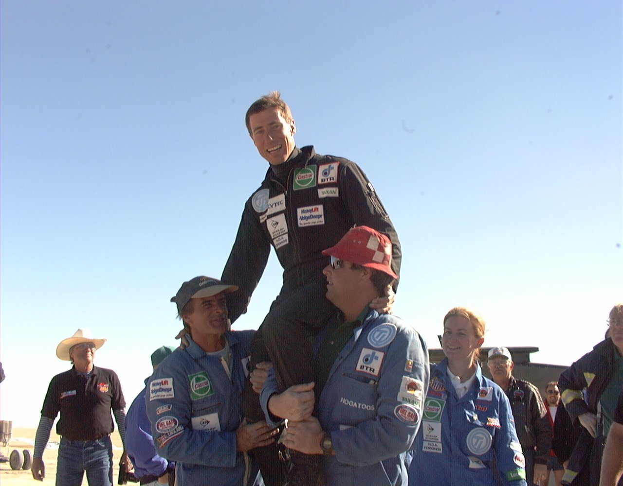 Andy Green hoisted on the shoulders of the ThrustSSC crew after setting the land speed record