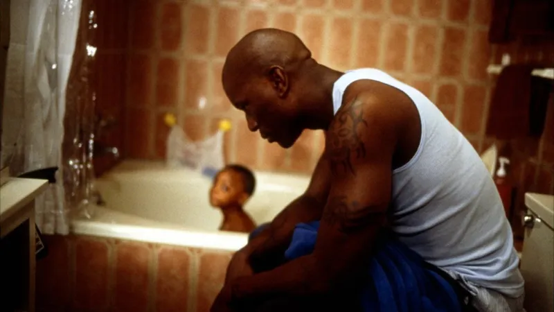 Ving Rhames as Melvin bathing a baby in Baby Boy 2001