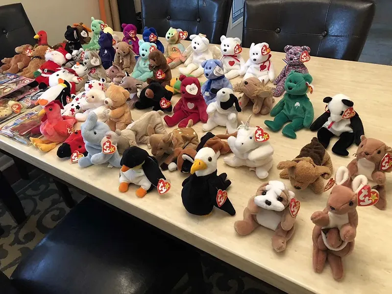 A large personal Beanie Babies collection spread across a dining table