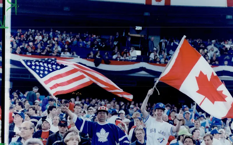 Fans wave American and Canadian flags inside SkyDome during the 1992 World Series