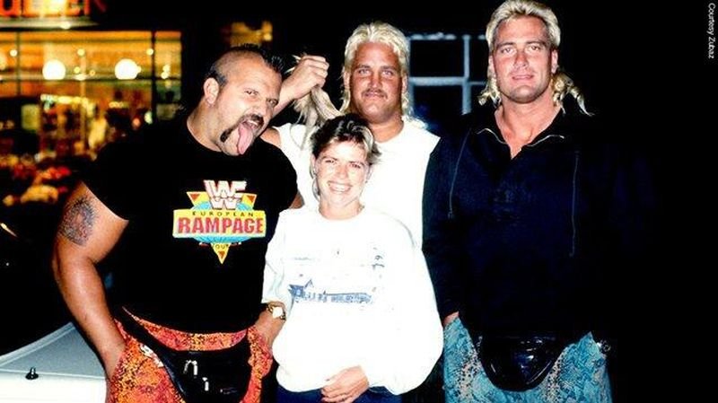 Road Warriors Hawk and Animal wearing Zubaz pants with fans outside a store