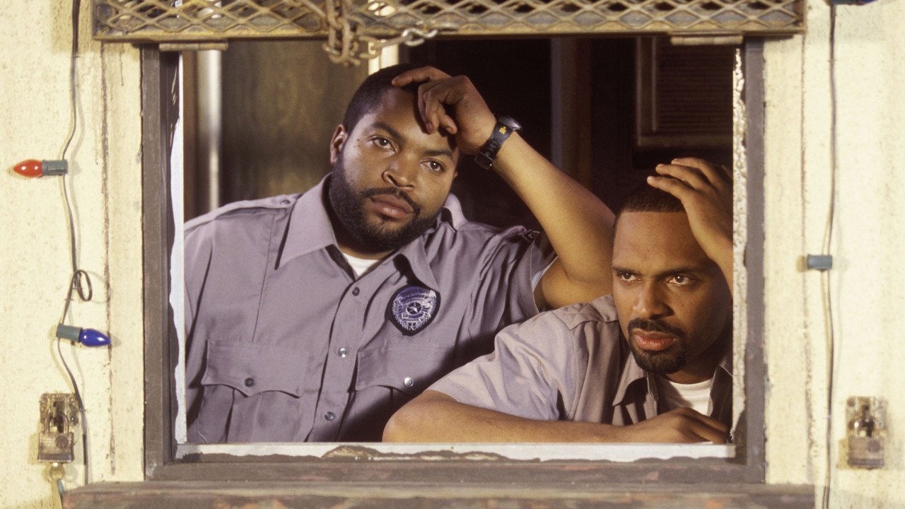 Craig and Day-Day as unarmed mall security guards looking out of their strip mall guard booth window in Friday After Next