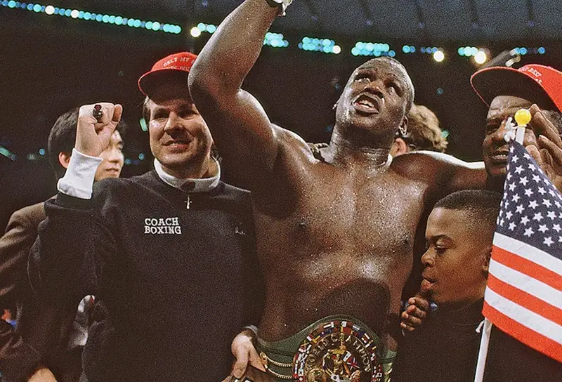 Buster Douglas celebrates with his championship belt moments after knocking out Mike Tyson in Tokyo, February 1990