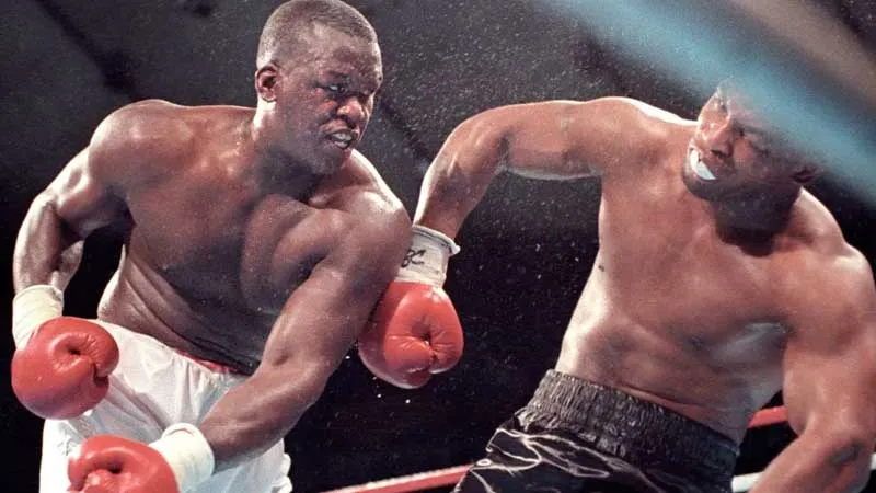 Buster Douglas lands a punch on Mike Tyson during their February 1990 Tokyo Dome upset, eight months before facing Evander Holyfield