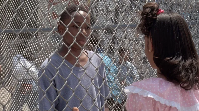 Michael talks through a chain-link fence in a scene from the 1994 film Fresh