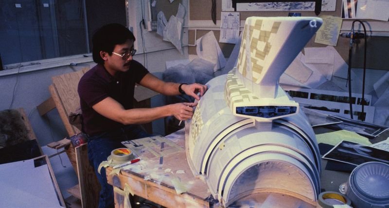 ILM model maker applying battle damage to the Enterprise miniature for Wrath of Khan