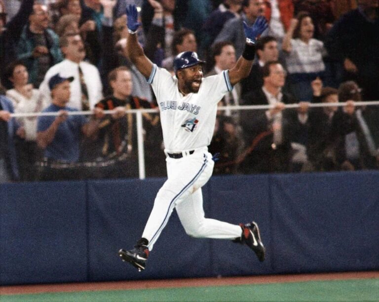 Joe Carter leaps and pumps his fist rounding the bases after his walk-off home run won the 1993 World Series
