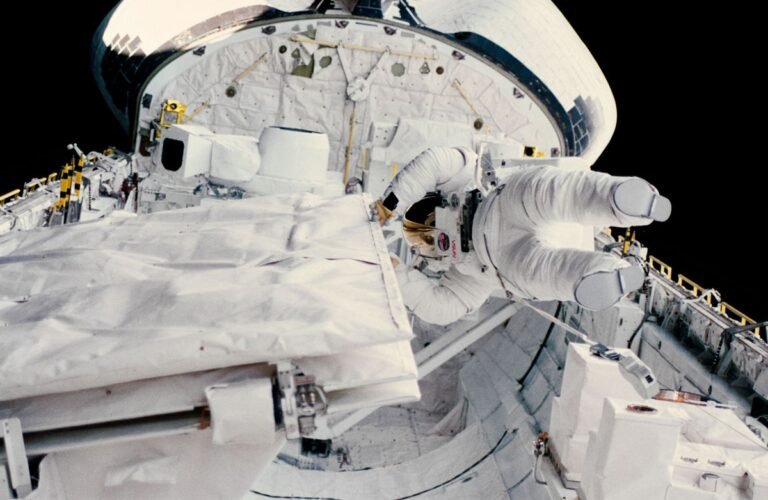 Kathryn Sullivan checking the SIR-B antenna latch during her historic October 11 1984 spacewalk