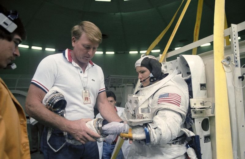 Kathryn Sullivan being suited into her spacewalk suit during 1984 training at Johnson Space Center