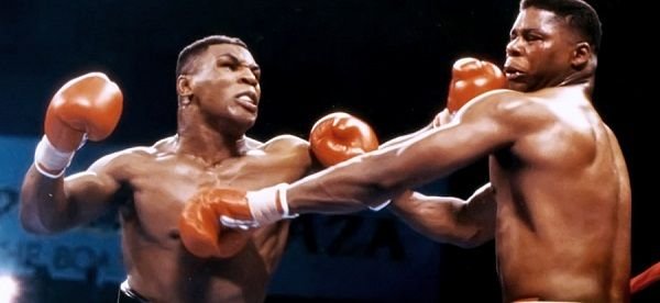 Mike Tyson throws a punch at Tyrell Biggs during their 1987 undisputed heavyweight title fight