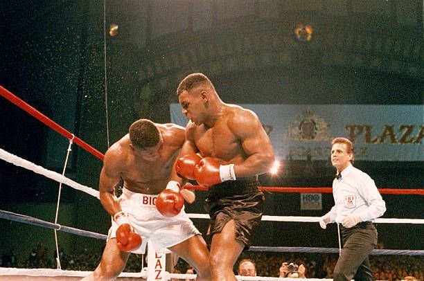 Mike Tyson lands a left hook on Tyrell Biggs during their October 16 1987 title fight