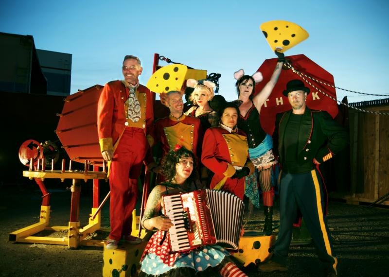 Costumed performers in mouse and cheese costumes posing with the Life Size Mousetrap machine