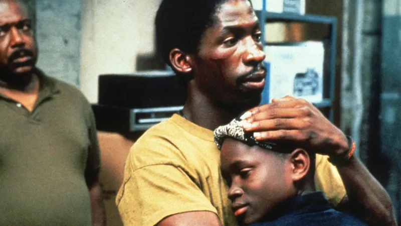 Close-up of Bobby Johnson holding his son in South Central 1992