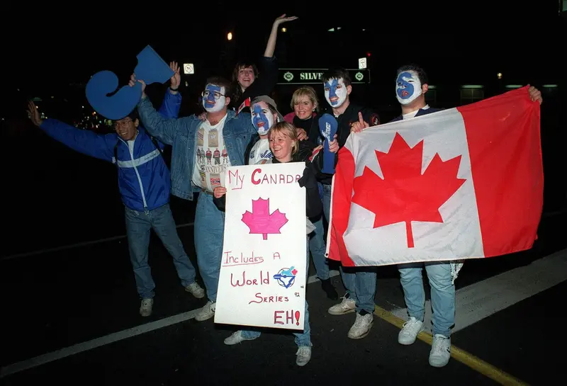 Toronto Blue Jays fans hold a Canadian flag sign celebrating the 1992 World Series championship