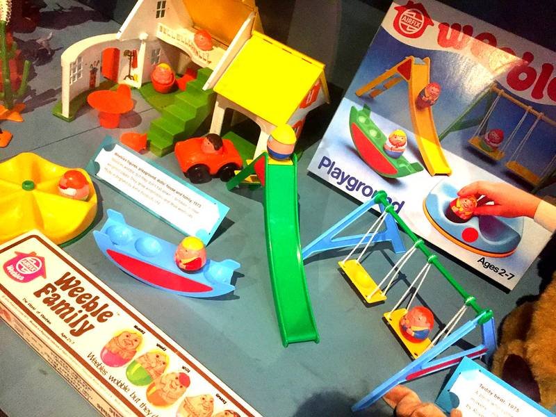 vintage Weebles family figures on a playhouse slide toy
